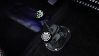 Interior view showing dual gear shift levers with black knobs labeled Wild Horses Inc in Classic Ford Bronco.