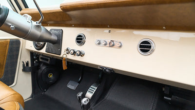 Dashboard with steering column, air vents, control knobs, and classic Ford Bronco emblem