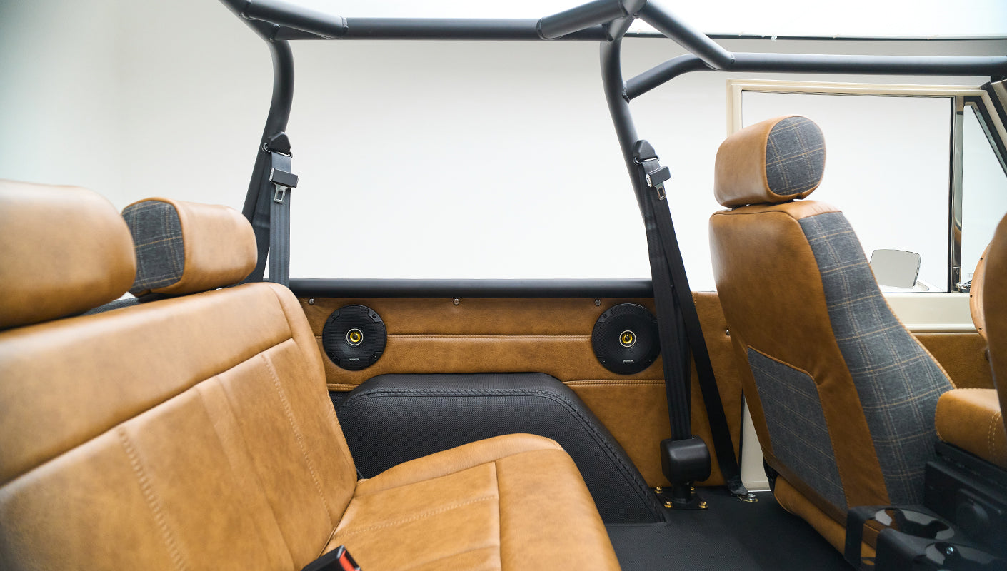 Classic Ford Bronco rear seats and front seat backs with upholstery in brown leather and plaid fabric