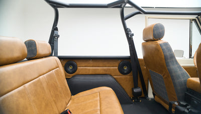 Classic Ford Bronco rear seats and front seat backs with upholstery in brown leather and plaid fabric