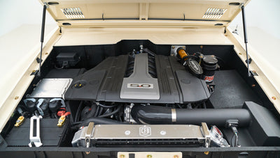 Engine bay angled view highlighting air filter, battery, and fluid reservoirs