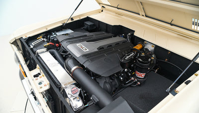 Engine compartment with clean layout, visible hoses, and a polished radiator cap