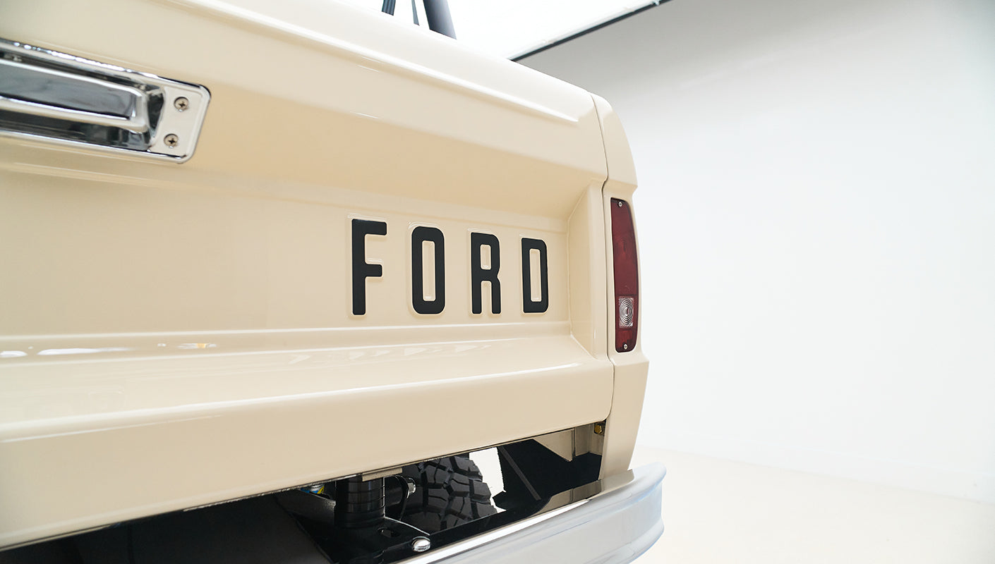 Rear of a Classic Ford Bronco with large black FORD lettering on tailgate