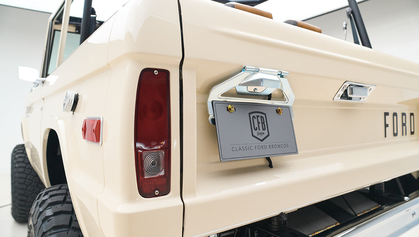 Rear left corner of Classic Ford Bronco showing taillight and license plate holder