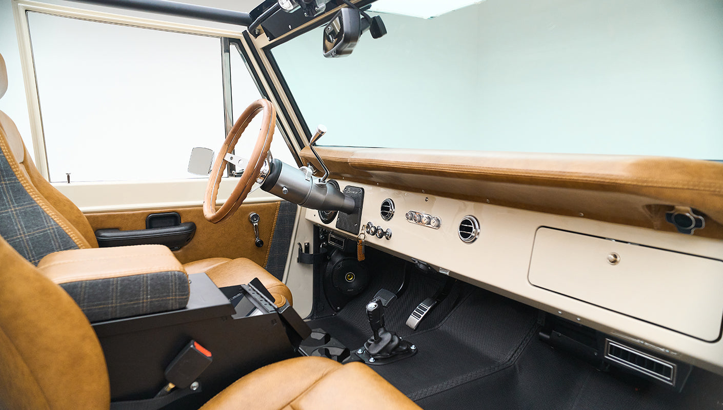 Dashboard close-up with cream color, control knobs, and keychain labeled CFB