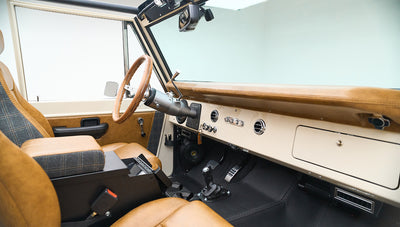 Dashboard close-up with cream color, control knobs, and keychain labeled CFB