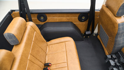 Rear seats of Classic Ford Bronco with tan leather and speaker installation