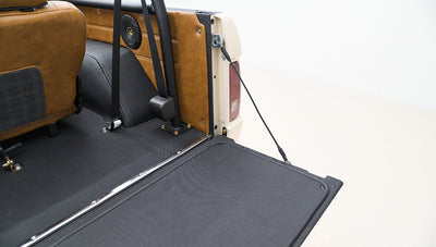 Open rear section of Classic Ford Bronco showing tailgate and rear interior panels