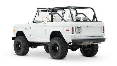 Classic Ford Bronco 1966 white open-top vehicle seen from rear-side angle