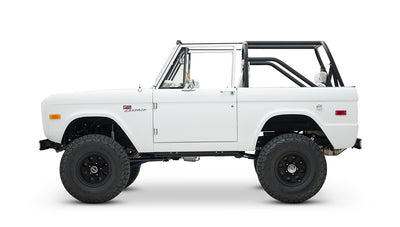 Side view of Classic Ford Bronco with white body and black off-road wheels