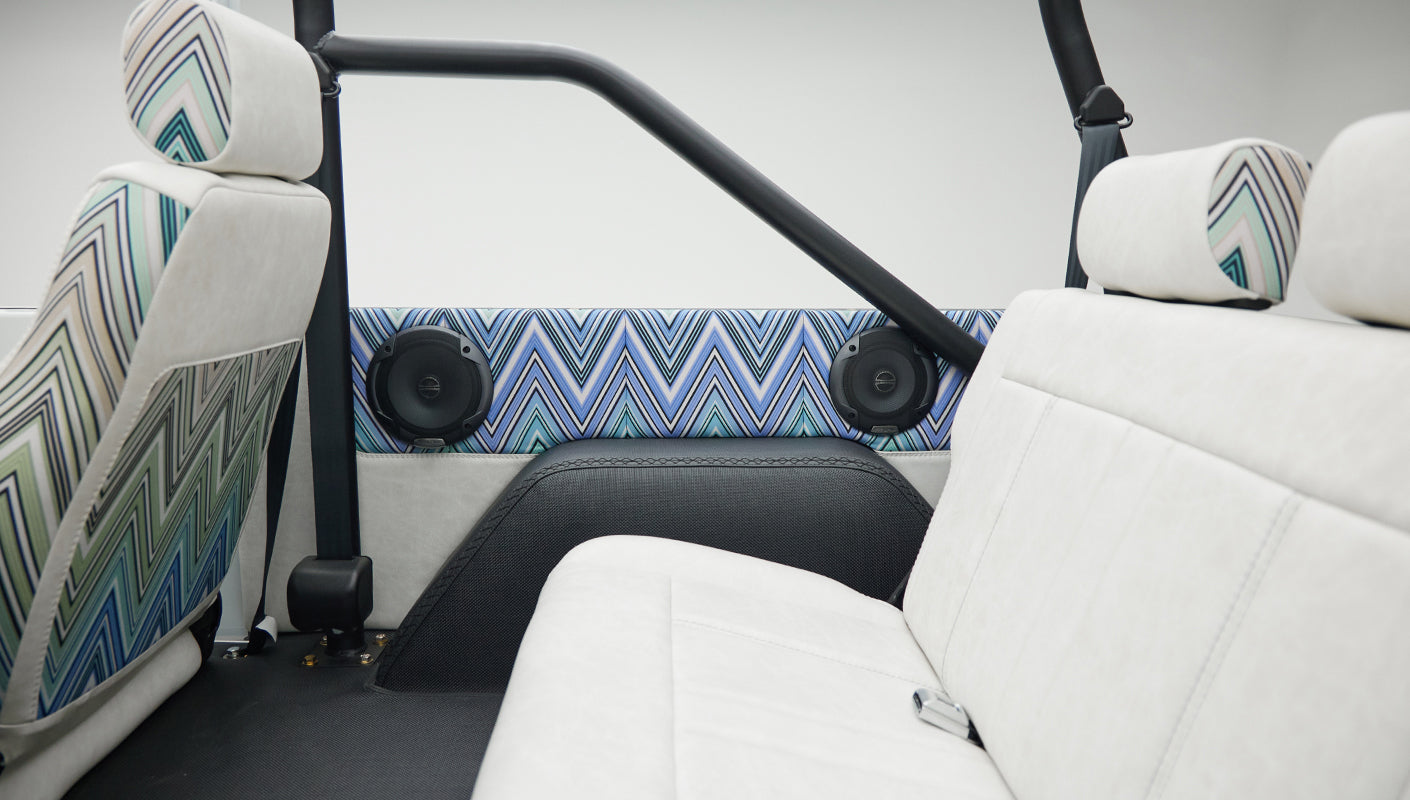 View of rear seats and interior side panel speakers inside Classic Ford Bronco