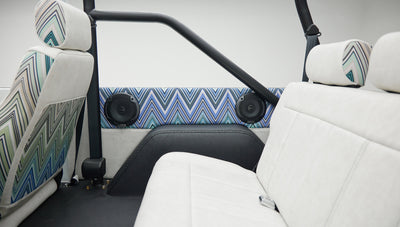 View of rear seats and interior side panel speakers inside Classic Ford Bronco
