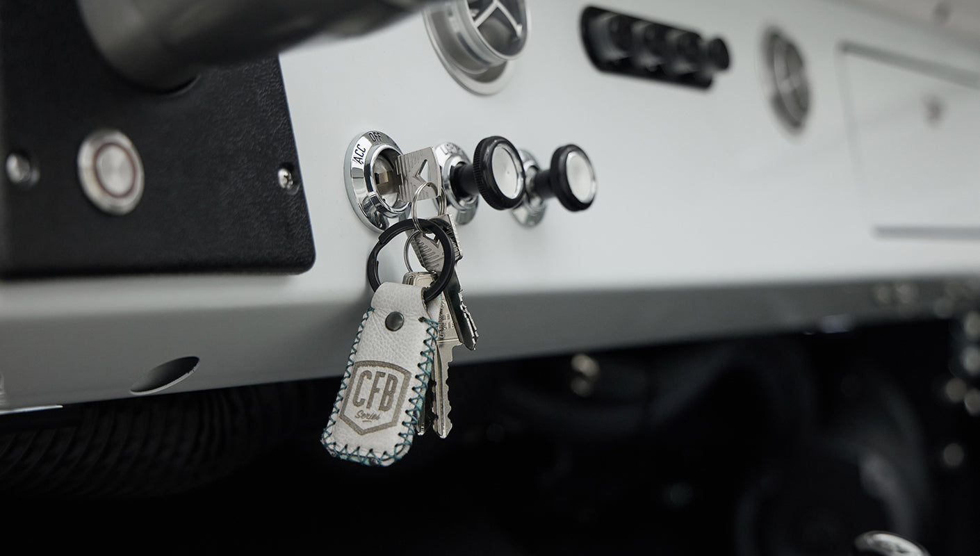 Close-up of Classic Ford Bronco dashboard with key in ignition and control knobs