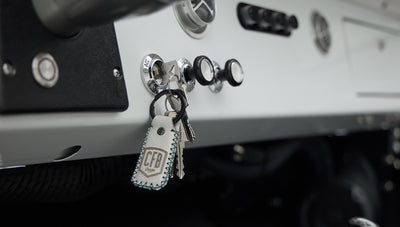 Close-up of Classic Ford Bronco dashboard with key in ignition and control knobs