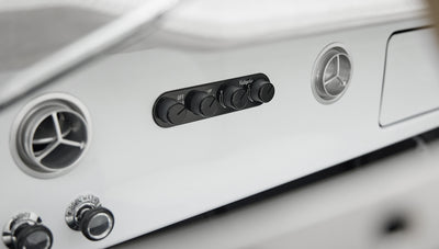 Classic Ford Bronco dashboard controls and air vents in white and silver finish