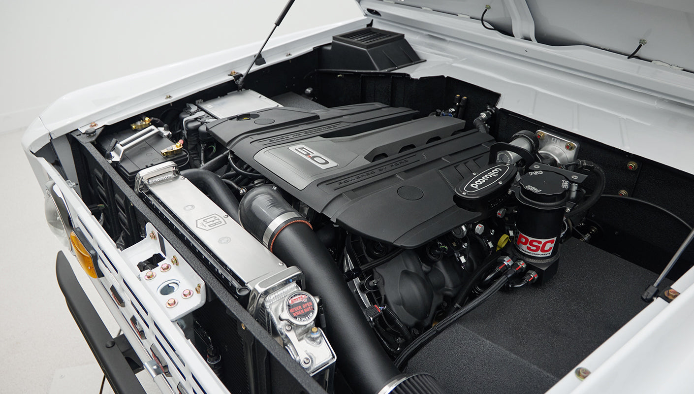 Close-up of air intake and PSC steering components mounted in engine bay