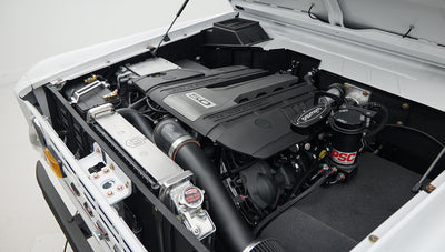 Close-up of air intake and PSC steering components mounted in engine bay