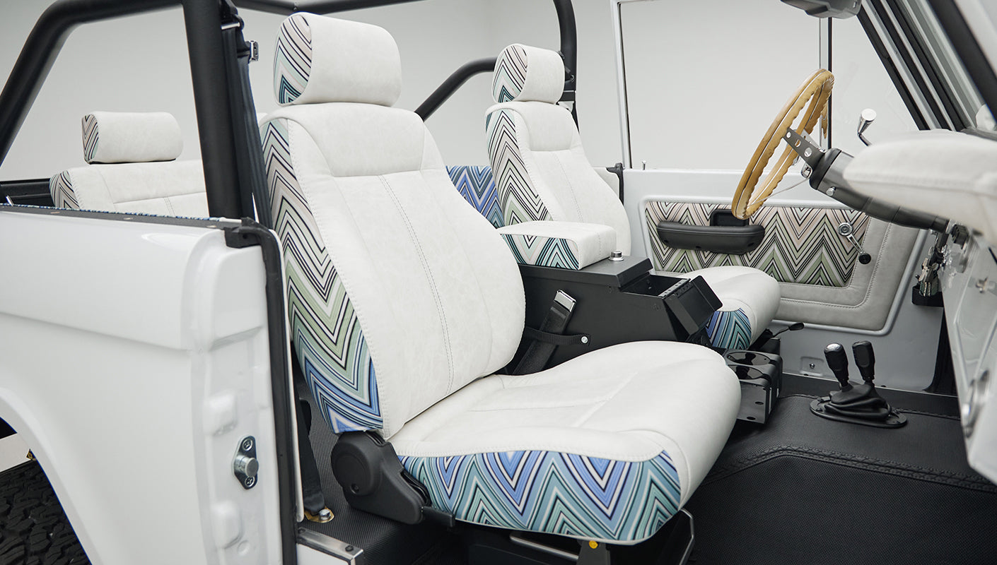 Side view of front two seats in Classic Ford Bronco with white and patterned upholstery