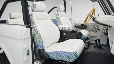 Side view of front two seats in Classic Ford Bronco with white and patterned upholstery