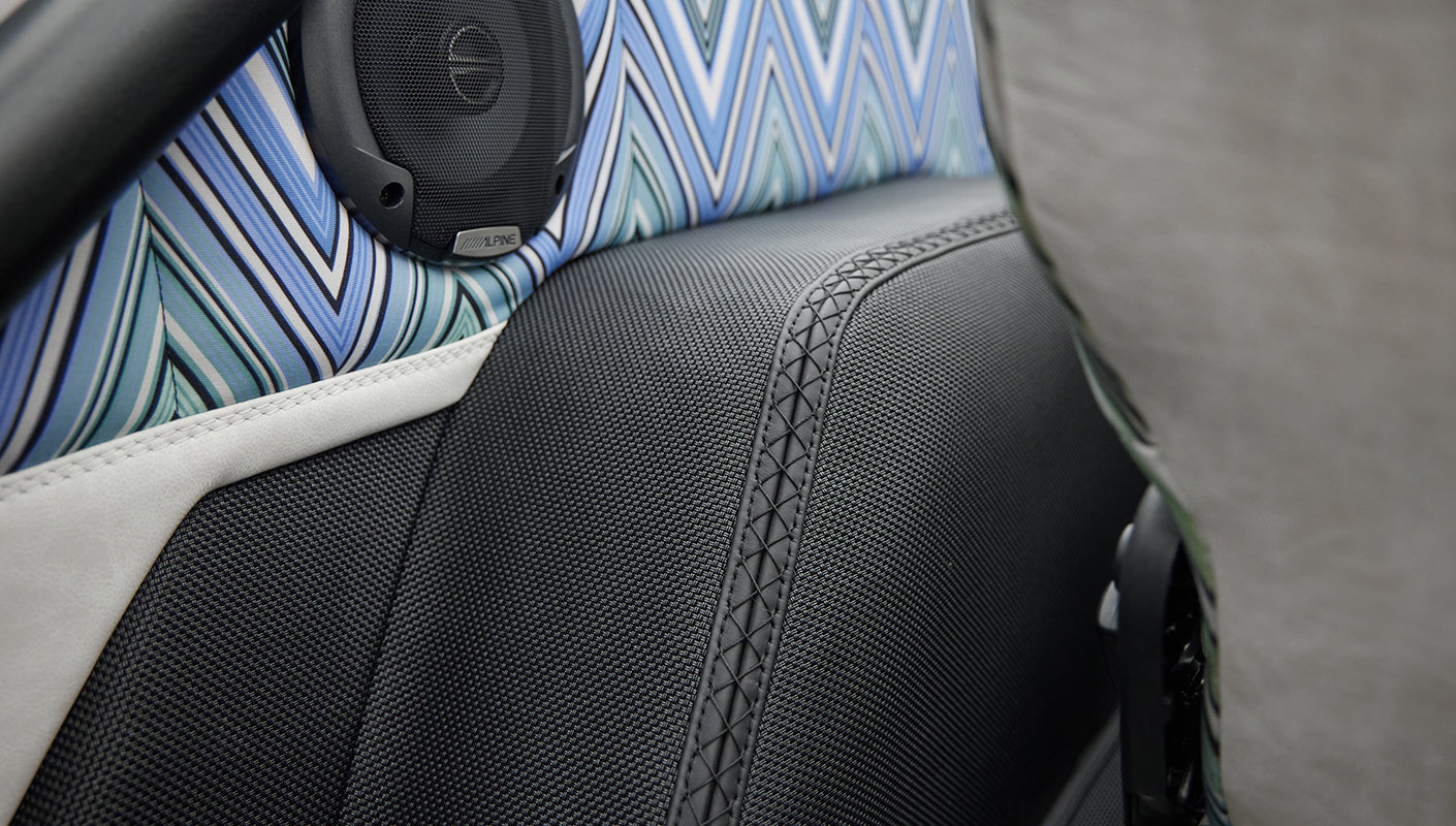 Classic Ford Bronco 1966 White Coyote Series close-up of patterned and black seat upholstery with Alpine speaker