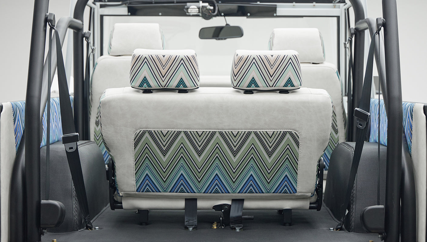 Classic Ford Bronco 1966 White Coyote Series rear seats with patterned and white upholstery and safety belts