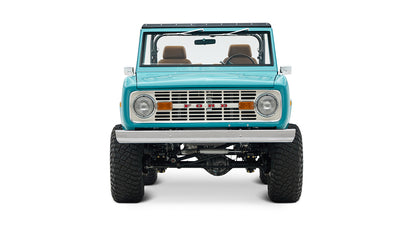 Front view of Classic Ford Bronco in Peacock Blue with round headlights and wide off-road tires