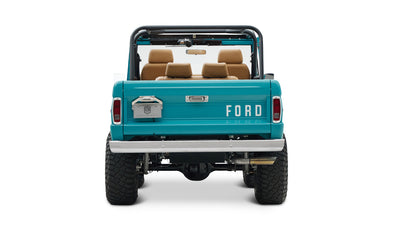 Rear view of Classic Ford Bronco in Peacock Blue showing FORD on tailgate and high clearance undercarriage