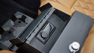 Open center console with Alpine power charger inside classic Ford Bronco