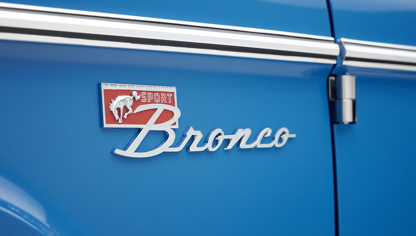 Close-up of the Classic Ford Bronco Sport emblem on the blue passenger door