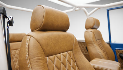 Two tan leather front seats with diamond stitching pattern inside Classic Ford Bronco