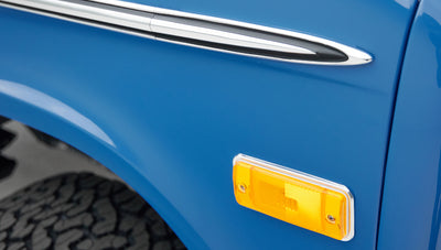 Close-up of amber side marker light and part of blue body panel of Classic Ford Bronco
