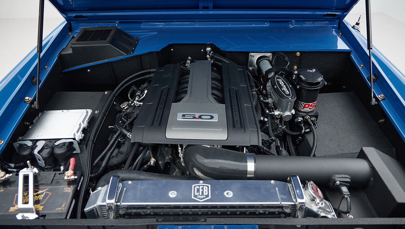 Engine bay of Classic Ford Bronco with detailed view of 5.0 engine and components