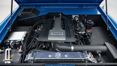 Engine bay of Classic Ford Bronco with detailed view of 5.0 engine and components