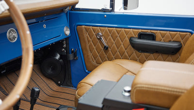 Tan leather seats and door panel with diamond stitching and speaker inside Classic Ford Bronco