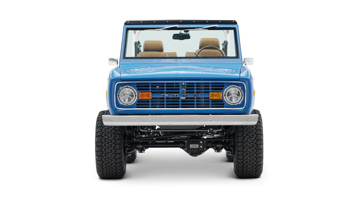 Front view of blue Classic Ford Bronco showing round headlights and Ford grille emblem