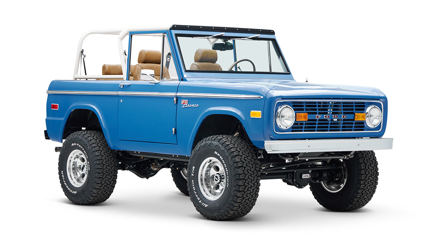 Front three-quarter view of blue Classic Ford Bronco with lifted suspension and large tires