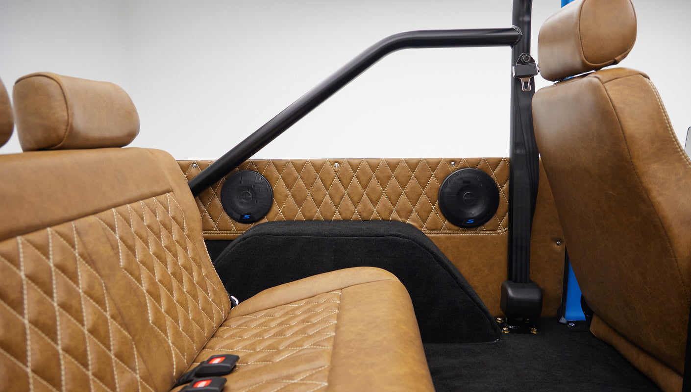1976 classic ford bronco in blue patina paint with whiskey leather interior rear panel