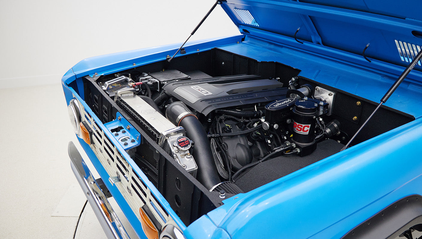 1976 classic ford bronco in blue patina paint with whiskey leather interior motor angle