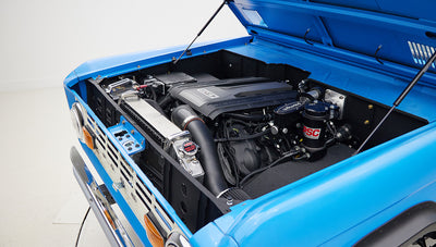 1976 classic ford bronco in blue patina paint with whiskey leather interior motor angle
