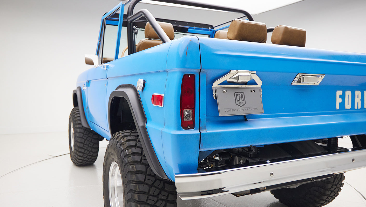 1976 classic ford bronco in blue patina paint with whiskey leather interior rear angle exterior