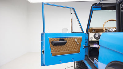 1976 classic ford bronco in blue patina paint with whiskey leather interior door panel