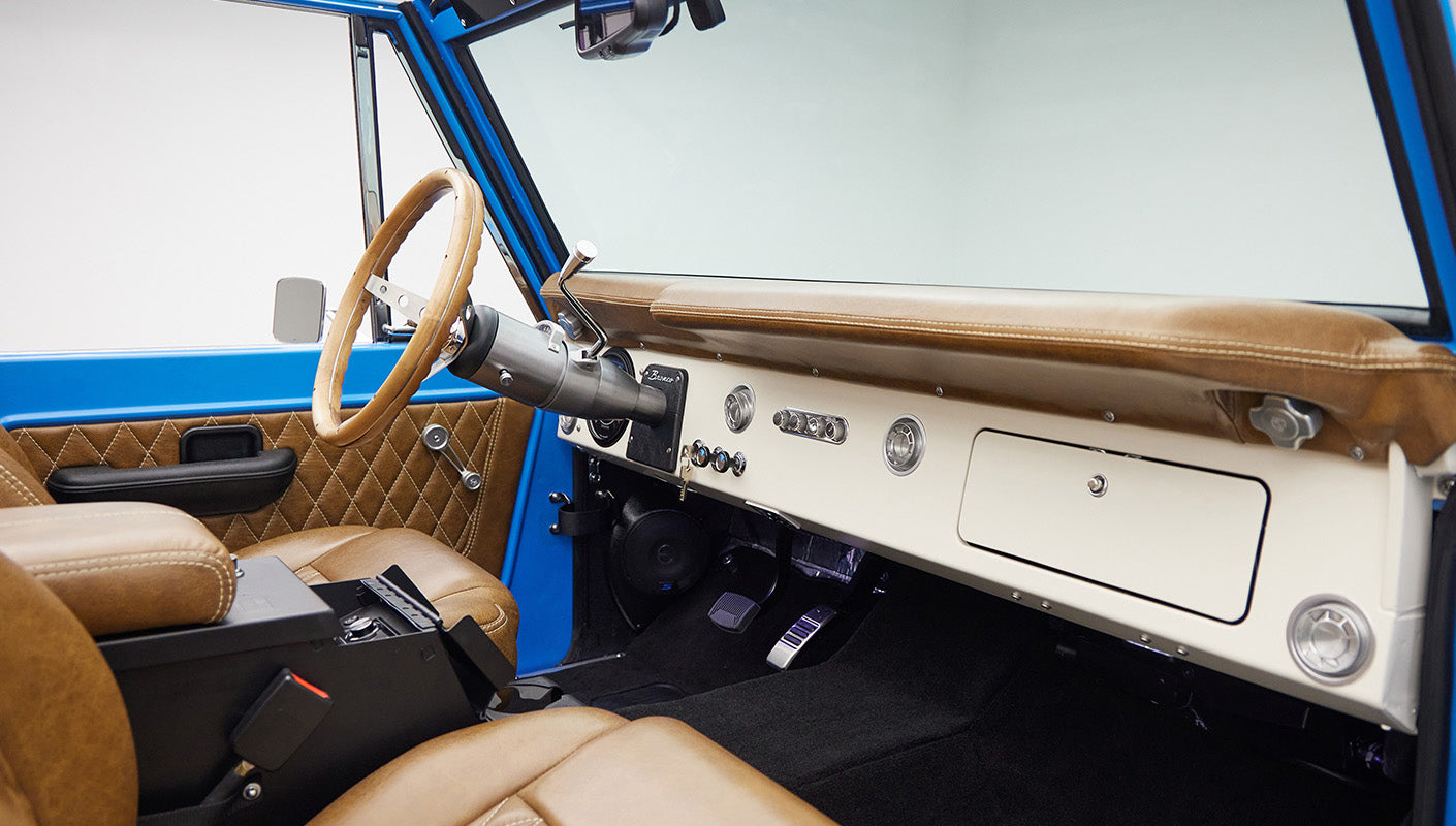 1976 classic ford bronco in blue patina paint with whiskey leather interior passenger dash