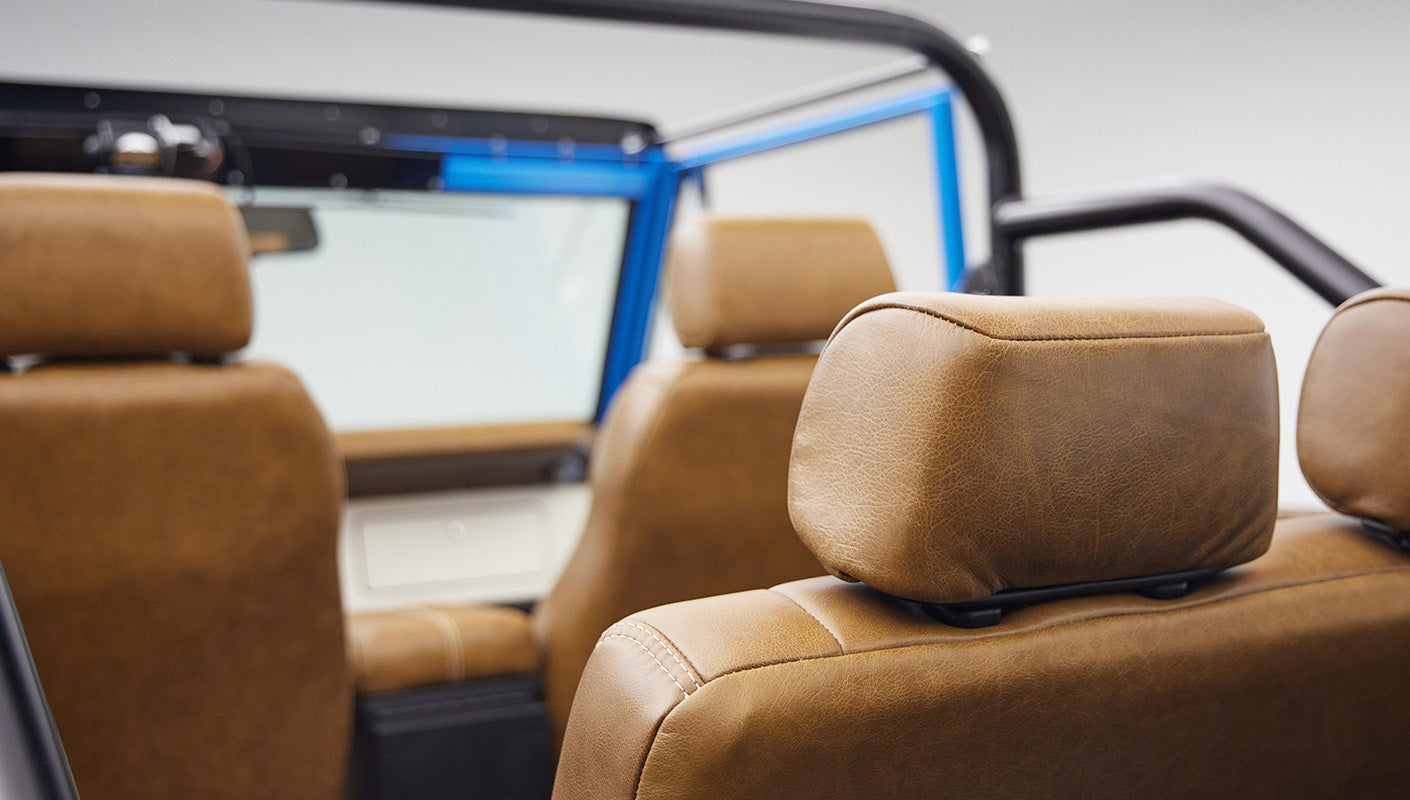 1976 classic ford bronco in blue patina paint with whiskey leather interior headrests