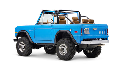 1976 classic ford bronco in blue patina paint with whiskey leather interior driver rear angle