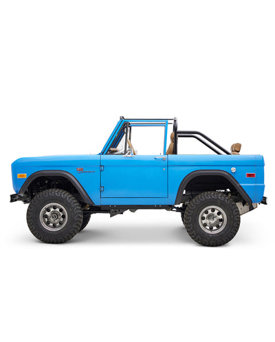 Blue Classic Ford Bronco side view with open top and roll cage