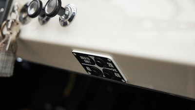 Dashboard control panel with black knobs and switches labeled for 2H, 4L, and 4H drive settings