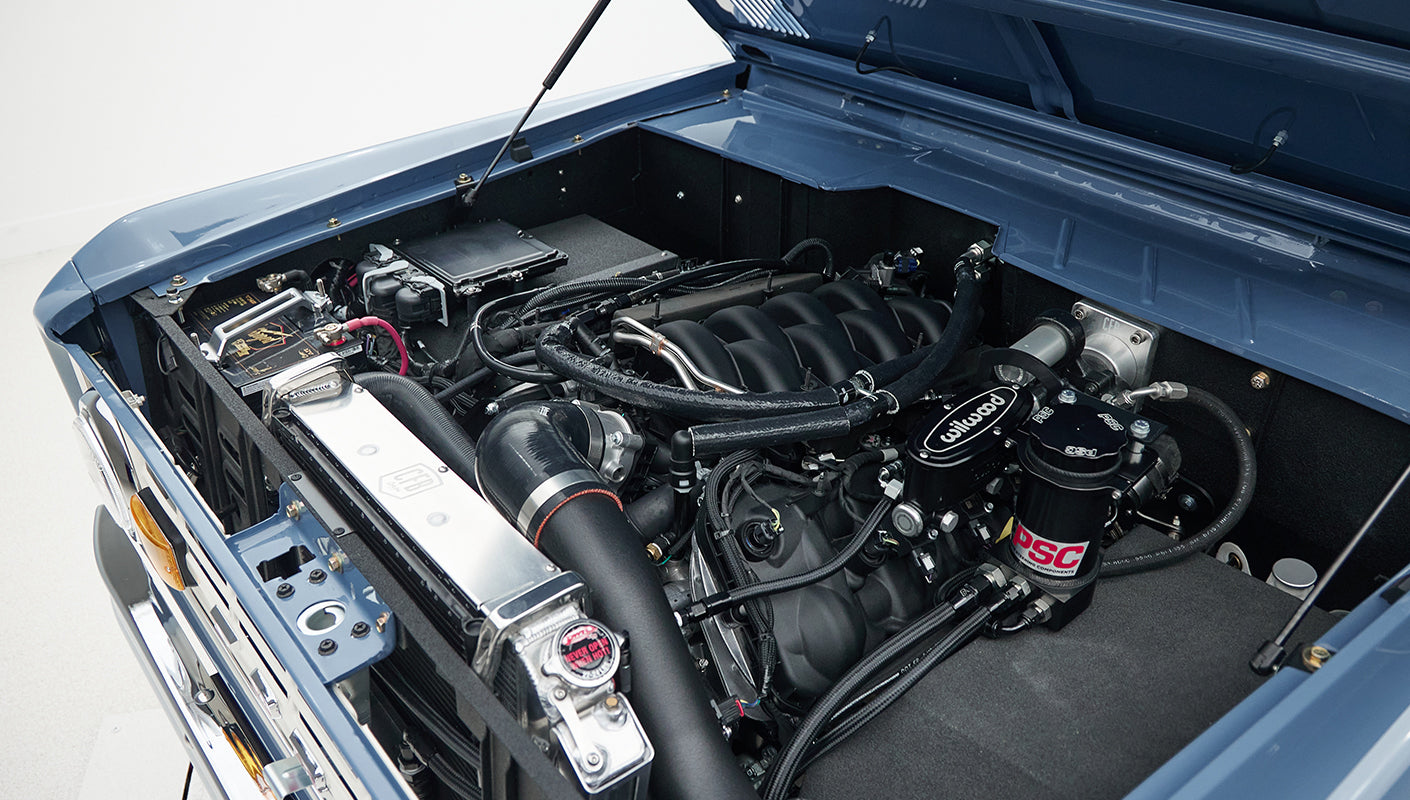 Classic Ford Bronco engine compartment showing detailed components and clean layout