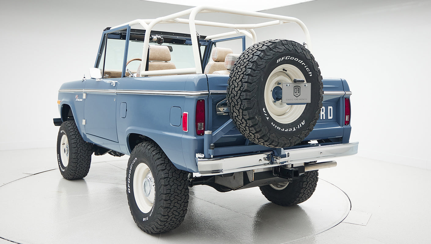 Rear three-quarter view of Classic Ford Bronco with roll cage and spare tire mounted