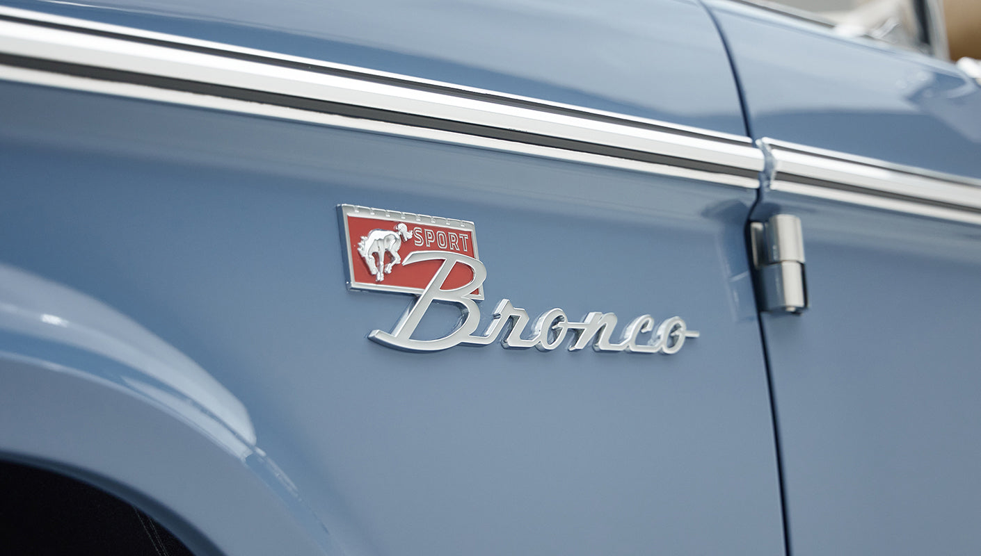 Close-up of Classic Ford Bronco red and silver Sport Bronco emblem on blue door panel