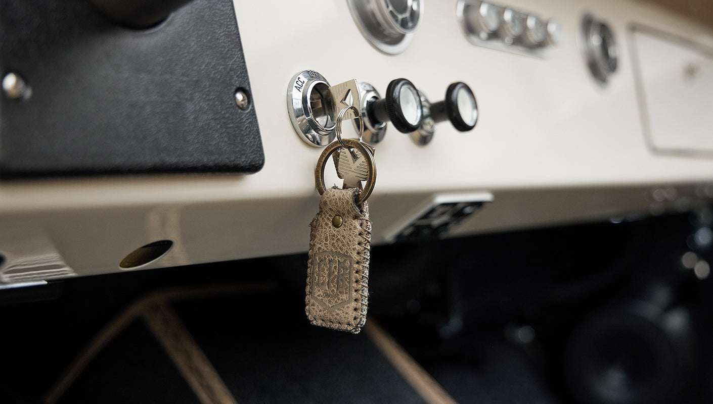 Close-up of leather keychain hanging from dashboard of Classic Ford Bronco